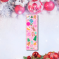 Pink Christmas bookmark with reindeer, gingerbread, and snowman illustrations — Tomes & Troves