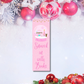 Pink “Snowed In With Books” Christmas bookmark with snow globe illustration — Tomes & Troves