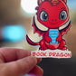 Book Dragon Sticker | Cute Red Dragon Holding ‘How to Train Your Human’ Book | Waterproof Die Cut Sticker for Readers & Fantasy Lovers - Tomes and Troves