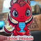 Book Dragon Sticker | Cute Red Dragon Holding ‘How to Train Your Human’ Book | Waterproof Die Cut Sticker for Readers & Fantasy Lovers - Tomes and Troves
